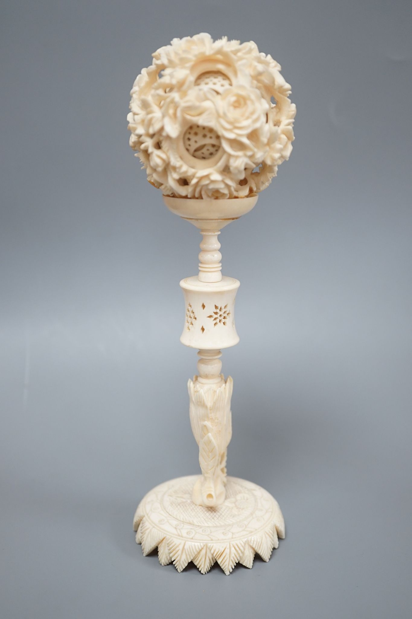 An early 20th century Chinese ivory concentric puzzle ball and stand 20cm total height